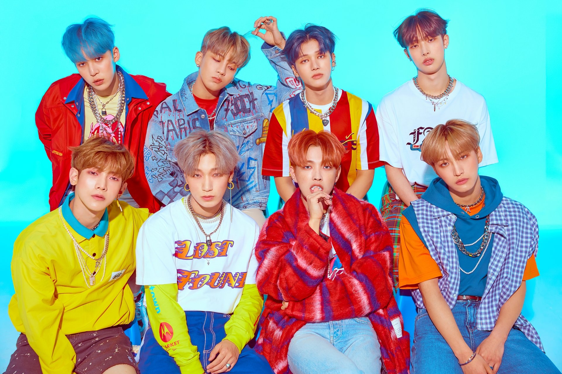 HD desktop wallpaper of ATEEZ members posing against a vibrant blue background.