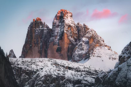 Snow-capped Tre Cime di Lavaredo mountain peaks bathed in soft light, captured in stunning 8K Ultra HD as a nature desktop wallpaper background.