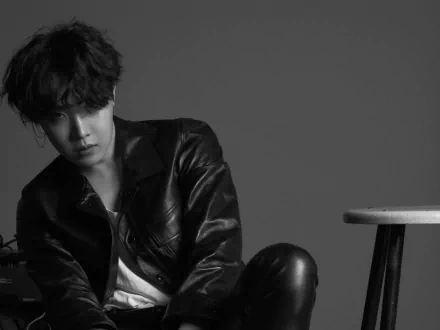 Black and white HD desktop wallpaper featuring J-Hope (Jung Hoseok) from BTS, dressed in leather, embodying K-pop style and music artistry.