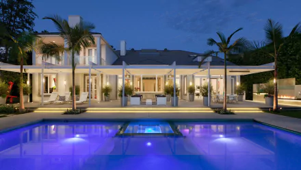 HD desktop wallpaper showcasing a luxurious man-made pool in front of a modern villa at dusk, framed by palm trees and ambient lighting.