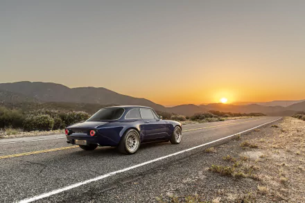 Totem Automobili GT Electric vehicle, an electric car on an open highway at sunset with mountains, presented as an 8K Ultra HD PC desktop wallpaper and background.