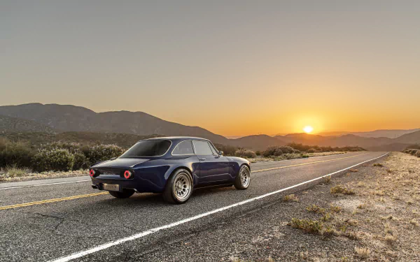 Totem Automobili GT Electric vehicle, an electric car on an open highway at sunset with mountains, presented as an 8K Ultra HD PC desktop wallpaper and background.