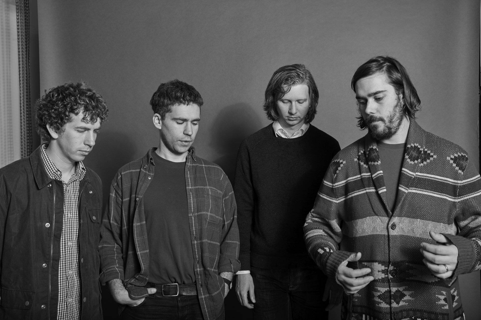 HD desktop wallpaper featuring a black and white photo of the band members of Parquet Courts standing together.