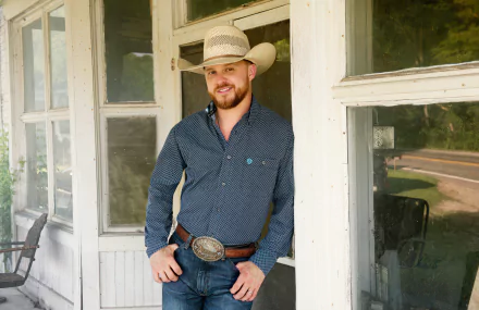 Man in cowboy attire standing on a porch, suitable as an HD desktop wallpaper and background, tagged Cody Johnson.