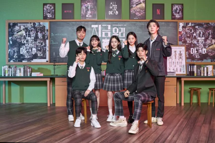 HD PC desktop wallpaper featuring the main cast of the TV show All of Us Are Dead in school uniforms, posing in a classroom with posters and books in the background.