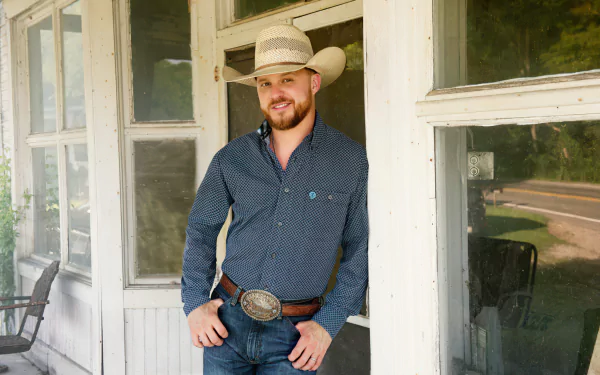 Man in cowboy attire standing on a porch, suitable as an HD desktop wallpaper and background, tagged Cody Johnson.
