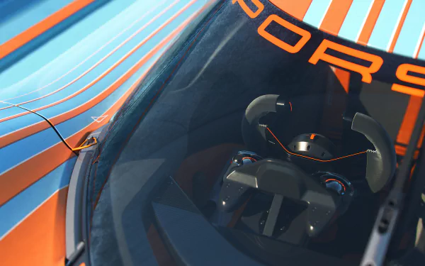 Close-up view of the Porsche Vision 908 concept with striking orange and blue livery, showcasing its sleek cockpit design, for HD desktop wallpaper and background use.