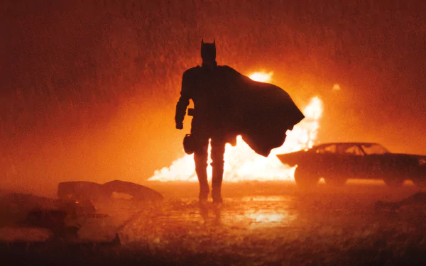 HD desktop wallpaper and background featuring a striking scene from the movie The Batman. The silhouette of Batman is highlighted against a fiery background, creating a dramatic and intense visual.