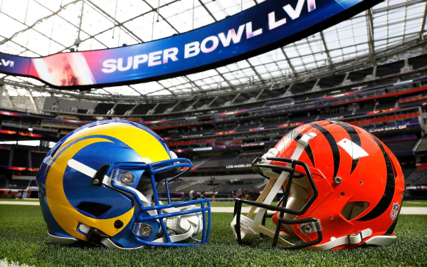 HD desktop wallpaper featuring helmets of the Cincinnati Bengals and Los Angeles Rams facing off inside a stadium with Super Bowl LVI signage overhead.