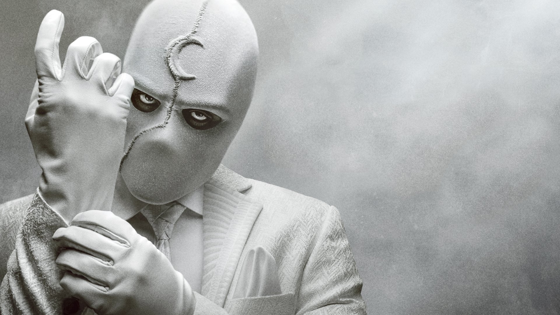 Moon Knight from the TV show in a white suit and mask, adjusting a glove against a textured gray backdrop — 4K Ultra HD PC desktop wallpaper and background.
