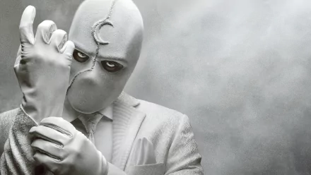 Moon Knight from the TV show in a white suit and mask, adjusting a glove against a textured gray backdrop — 4K Ultra HD PC desktop wallpaper and background.