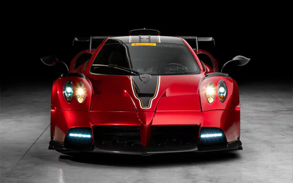 Front view of a red Pagani Imola supercar with illuminated headlights, showcased as an 8K Ultra HD PC desktop wallpaper and background against a dark backdrop.
