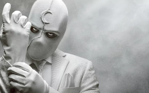 Moon Knight from the TV show in a white suit and mask, adjusting a glove against a textured gray backdrop — 4K Ultra HD PC desktop wallpaper and background.