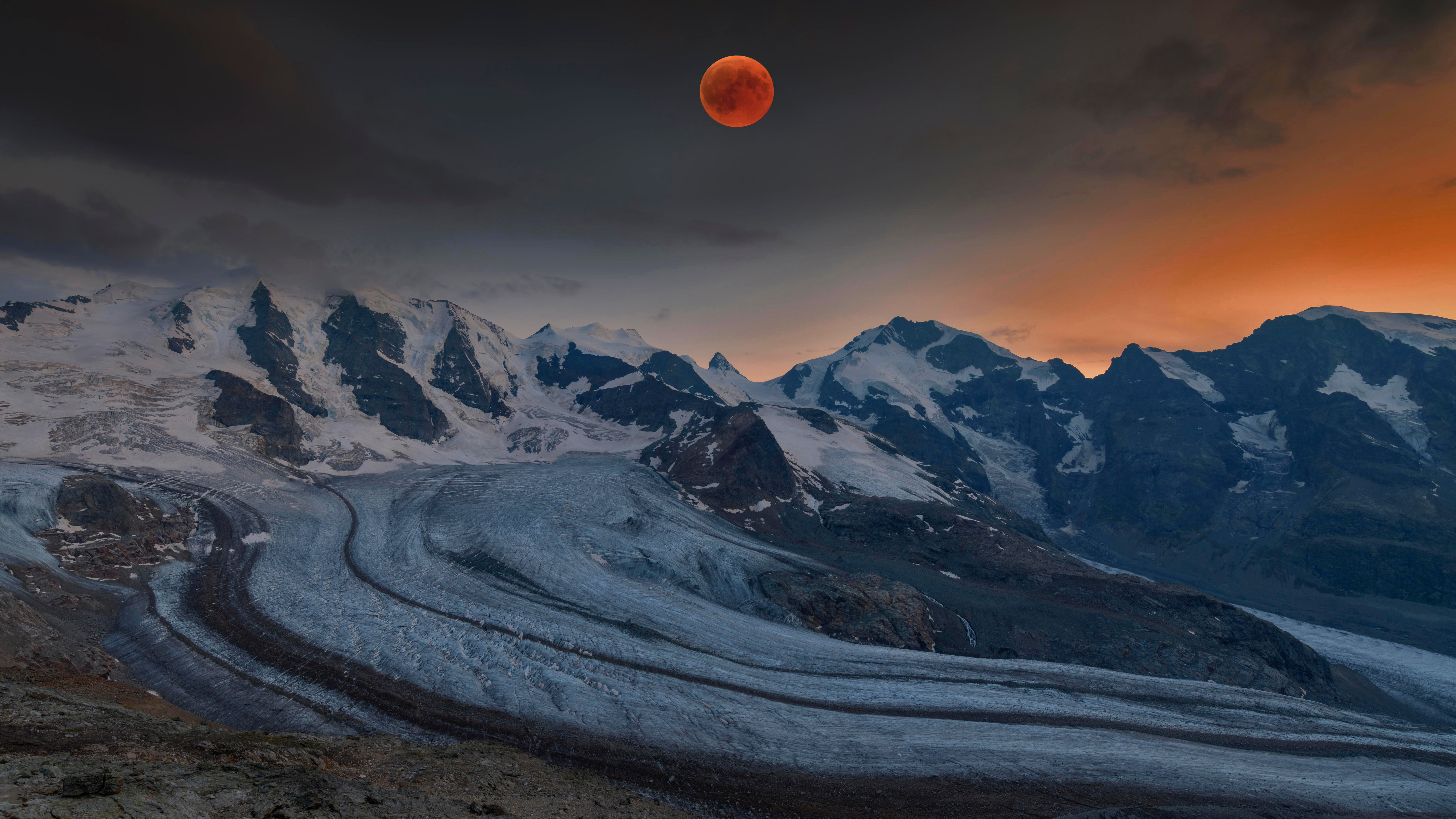 Panoramic view of the Bernina Range with blood moon, Eastern Alps, Engadin, Switzerland by Bernd Zoller