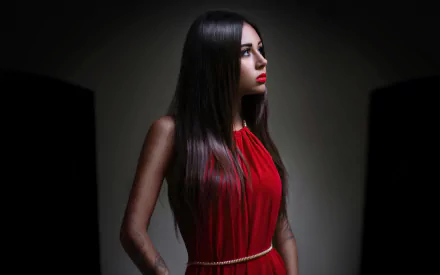 HD desktop wallpaper featuring a model with long black hair wearing a red dress, set against a dark background.