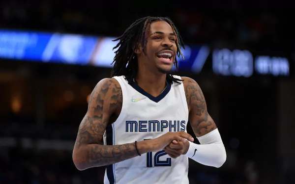 HD sports desktop wallpaper featuring basketball player Ja Morant in a Memphis jersey during a game, showcasing his athletic energy and focus.