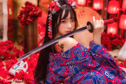 HD desktop wallpaper featuring an Asian woman in traditional attire holding a katana, surrounded by vibrant red decorations and floral accents.