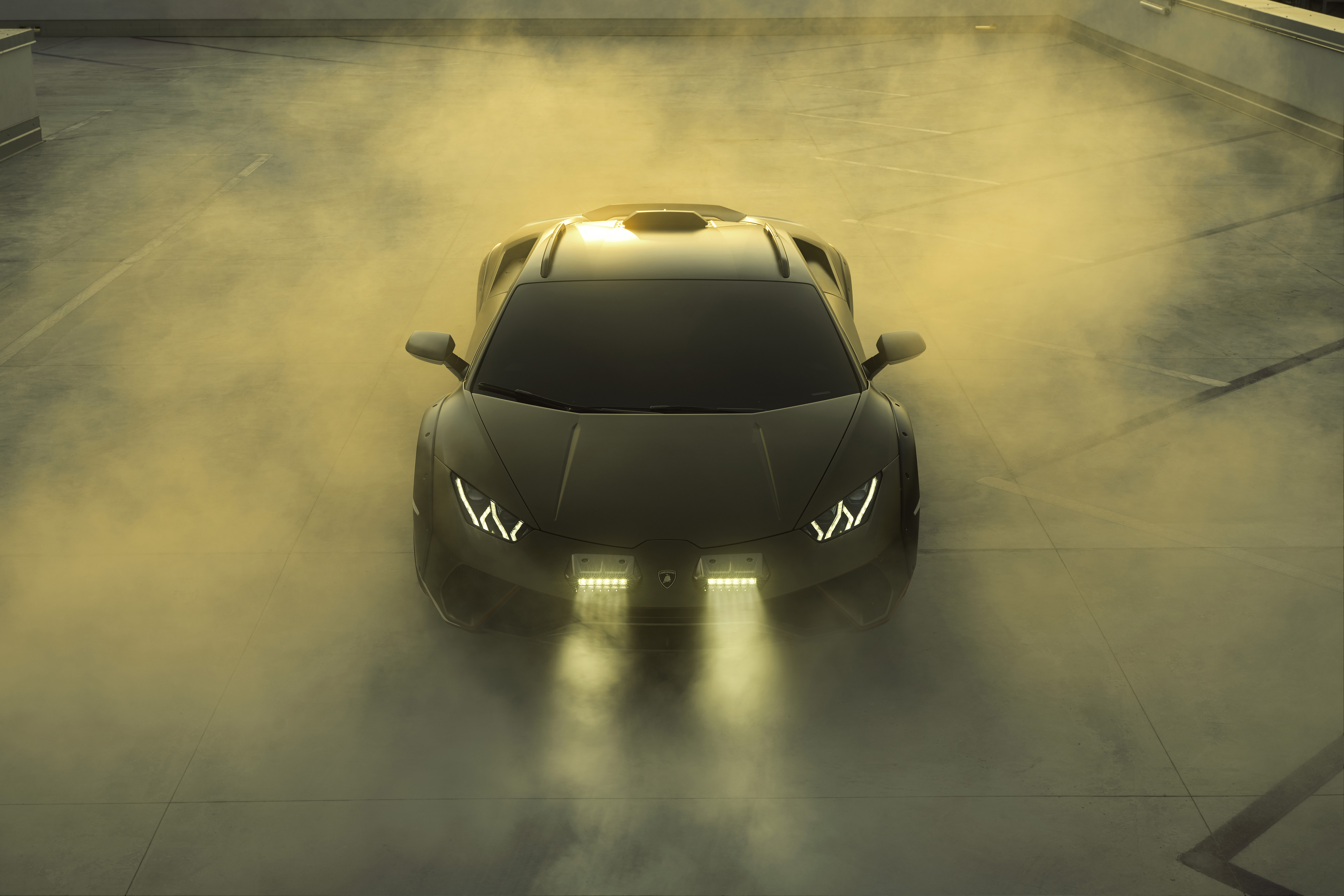 Lamborghini Huracán Sterrato speeding through a rugged terrain, a high-definition desktop wallpaper with a stunning background.