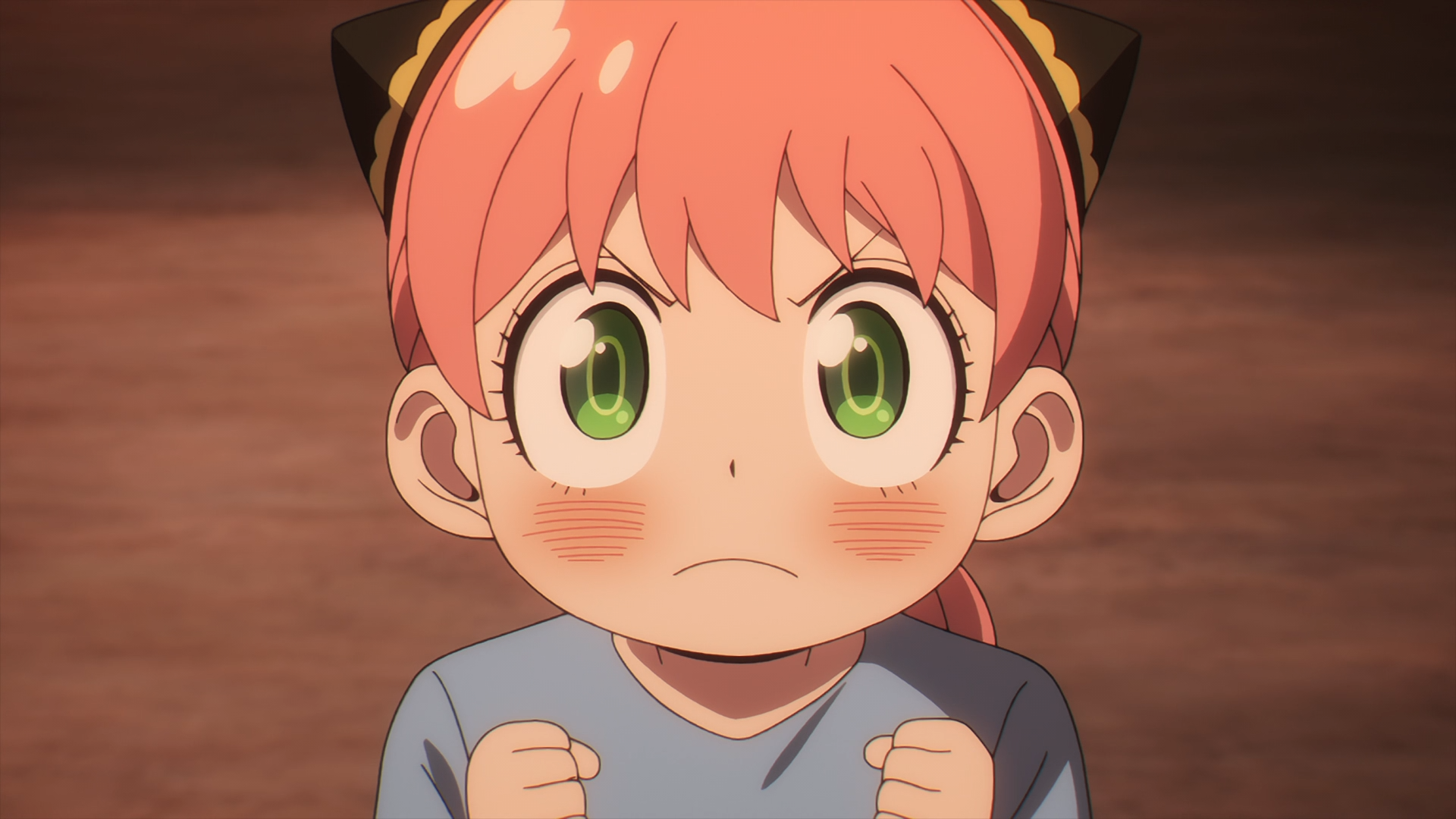 HD PC desktop wallpaper featuring Anya Forger from the anime Spy x Family with a focused expression and clenched fists.