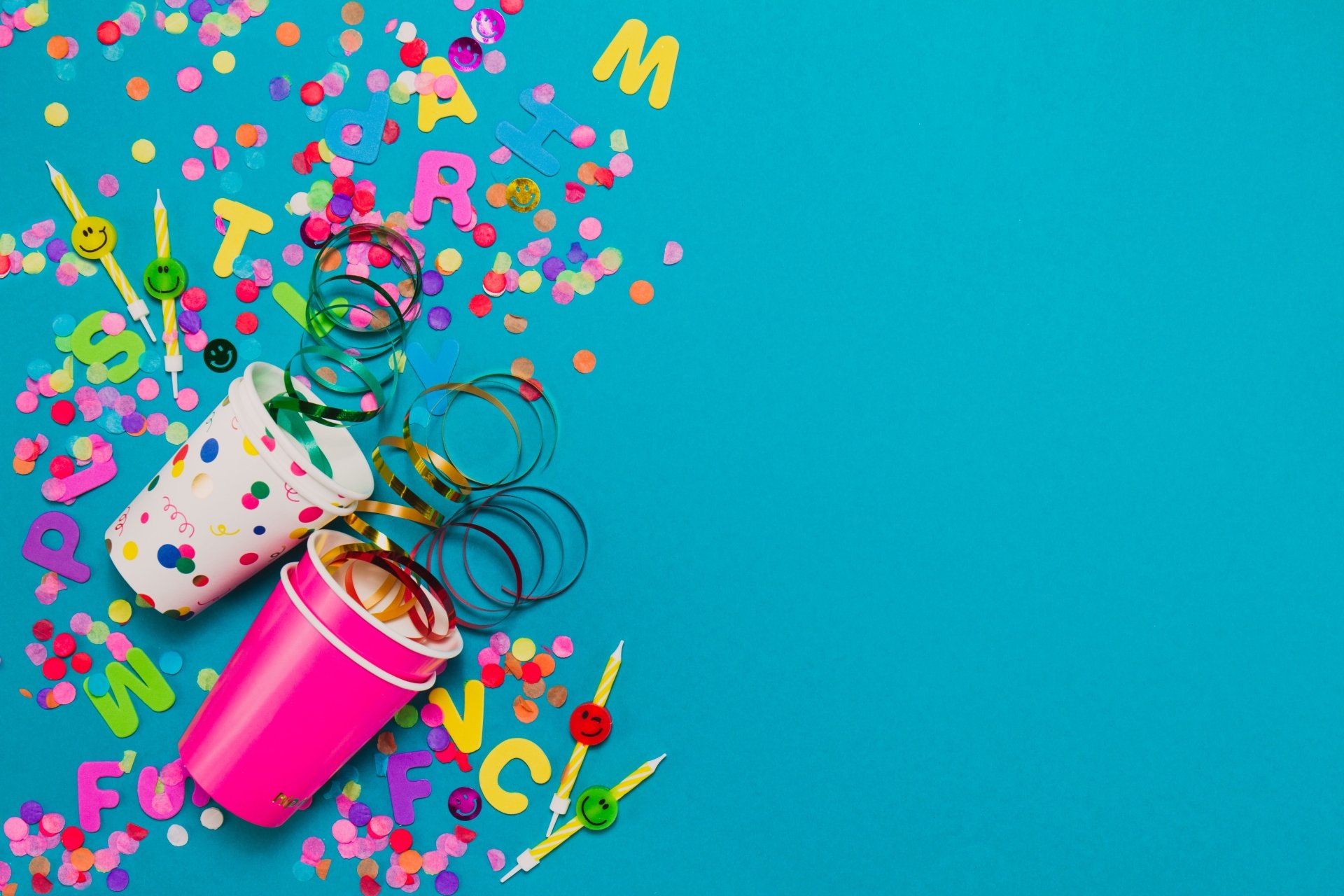 Vibrant 4K Ultra HD holiday and birthday-themed wallpaper featuring colorful party poppers, confetti, and streamers exploding against a bright blue background.
