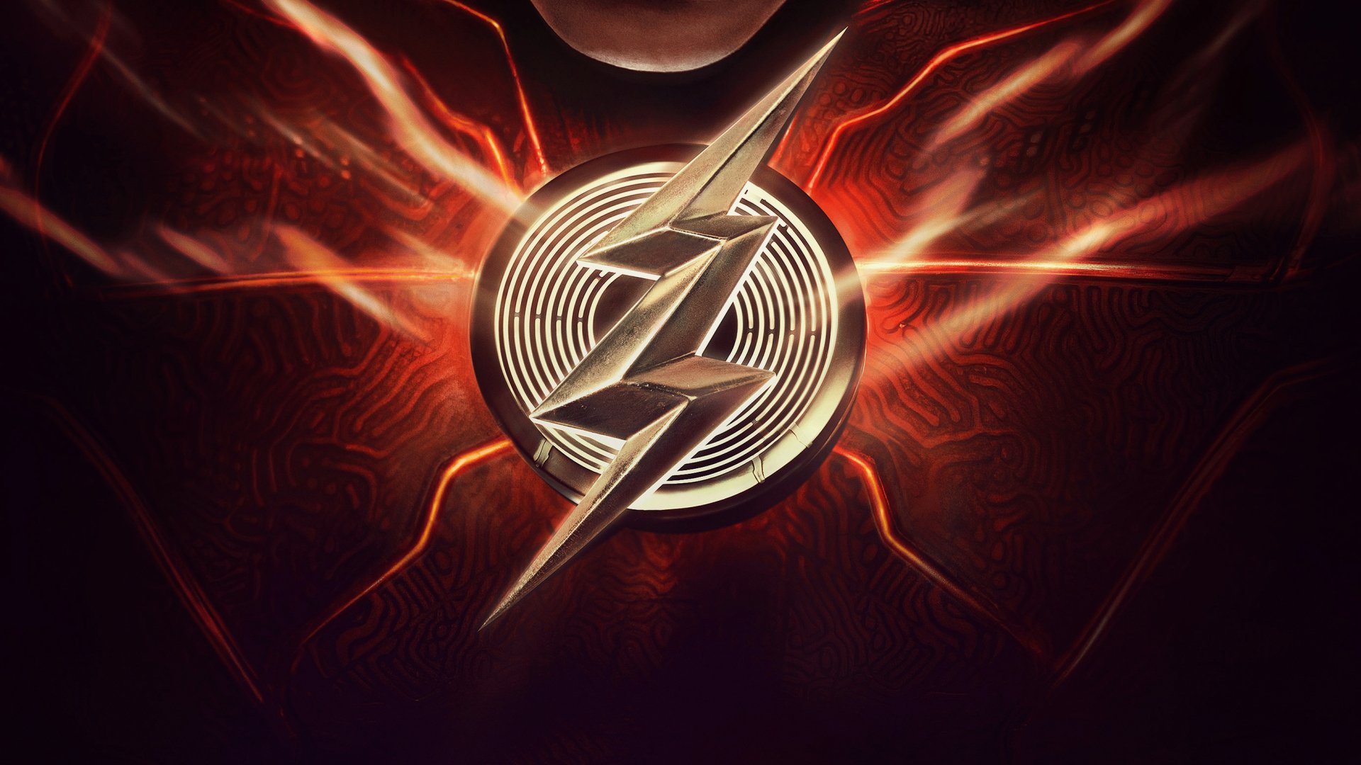 The Flash (2023) movie 2K Quad HD PC desktop wallpaper/background: a golden lightning-bolt emblem centered on a red, fiery textured field with radiating energy streaks.