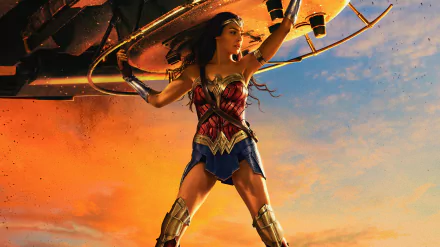 HD PC desktop wallpaper featuring Gal Gadot as Wonder Woman, poised heroically against a dramatic orange and blue sky background.