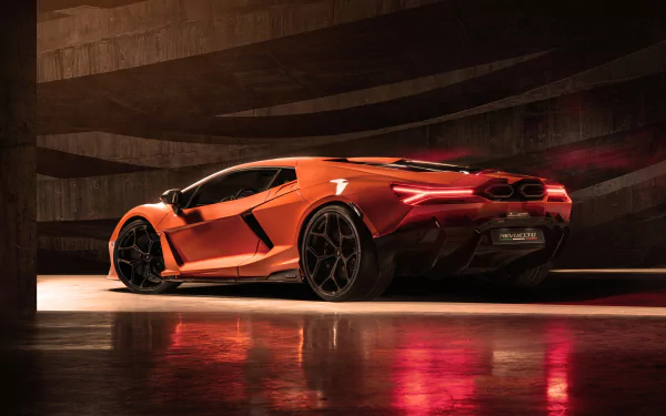 Orange Lamborghini Revuelto in a dim concrete garage with glossy reflections on the wet floor — 8K Ultra HD PC desktop wallpaper/background.