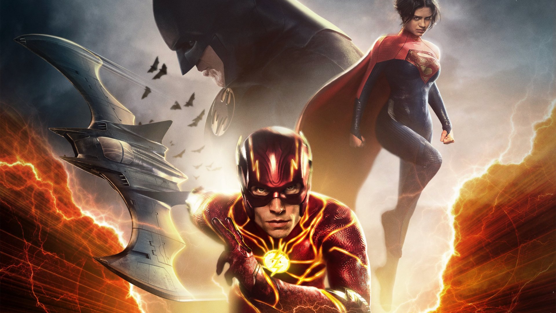HD PC desktop wallpaper featuring The Flash in his suit with Batman and Supergirl in the background from the 2023 movie The Flash.