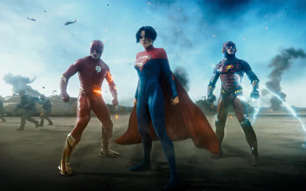 HD PC desktop wallpaper featuring The Flash (2023) alongside Superman and Batman, set in a dramatic battle scene with a smoky, blue-toned background.