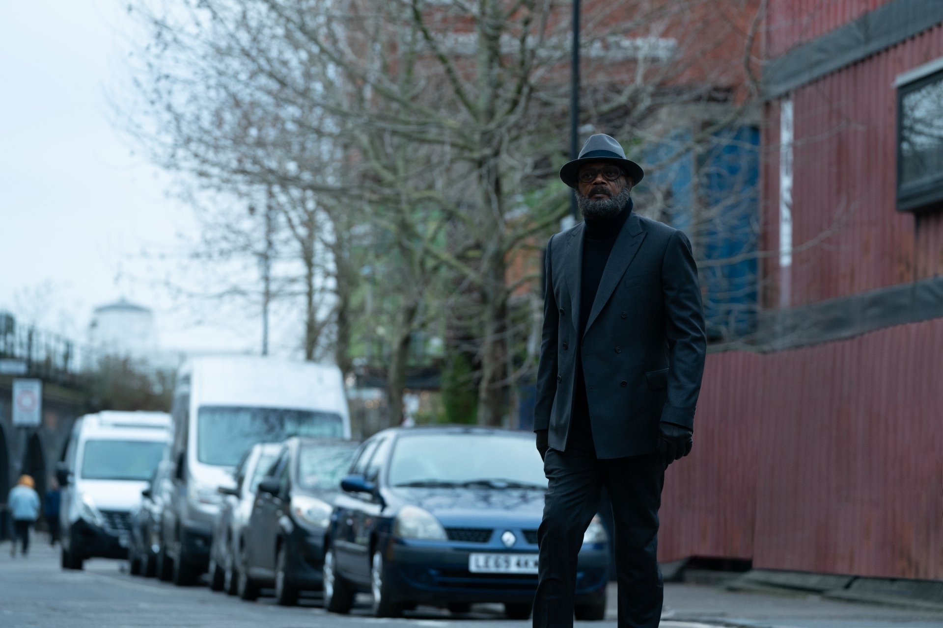 HD desktop wallpaper of a character from Secret Invasion standing confidently on a city street.