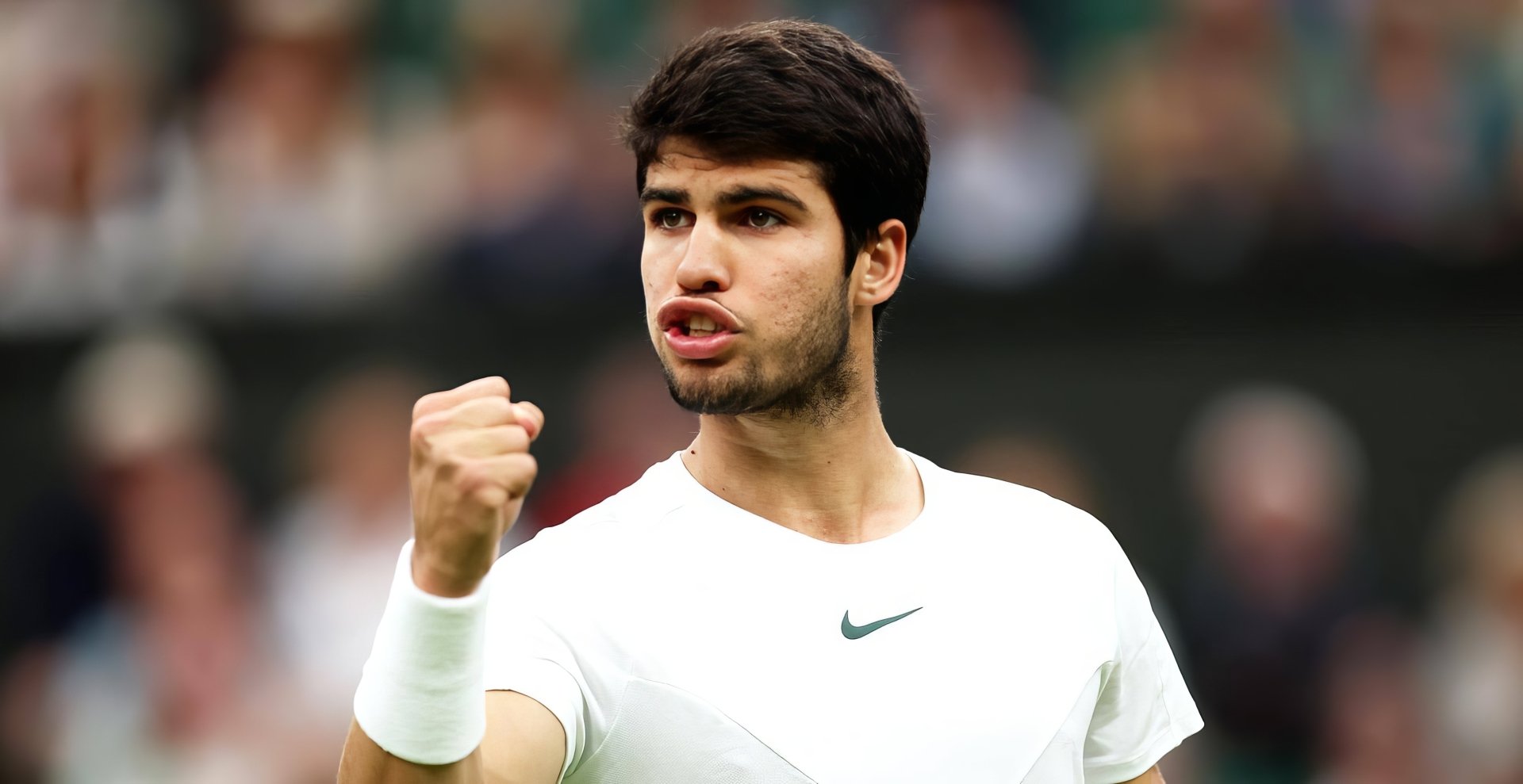 Carlos Alcaraz celebrates during a thrilling match at Wimbledon 2023. This HD desktop wallpaper captures the intensity and excitement of tennis in the spotlight.