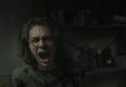 HD desktop wallpaper from Insidious: The Red Door featuring a person screaming in a dimly lit room.