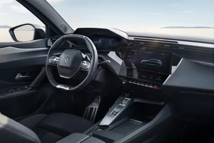 A sleek interior of a Peugeot e-308, showcasing modern design elements, advanced technology, and a spacious dashboard. This HD image serves as a stylish desktop wallpaper.