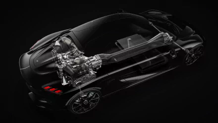 HD wallpaper of a Koenigsegg Gemera featuring a detailed transparent view of the engine and chassis on a black background.