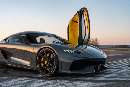 HD desktop wallpaper of Koenigsegg Gemera with open door on airstrip at sunset.