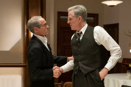 HD desktop wallpaper featuring two actors in character, shaking hands in a period-style setting, tagged with Oppenheimer, Robert Downey Jr., and Matthew Modine.