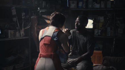 HD wallpaper featuring a dramatic scene from The Creator (2023) with John David Washington and a co-star in an intimate, dimly-lit setting.