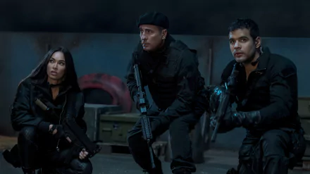 HD desktop wallpaper featuring three actors in tactical gear from the Expend4bles movie, poised for action in a dark, moody setting.