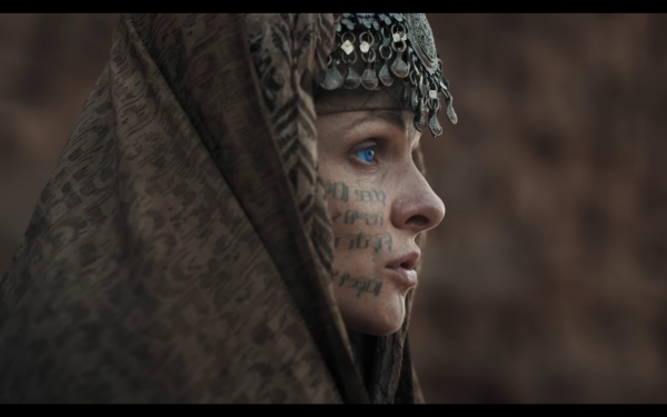 HD wallpaper featuring a profile view of Lady Jessica from Dune: Part Two, adorned with a patterned headscarf and facial markings.