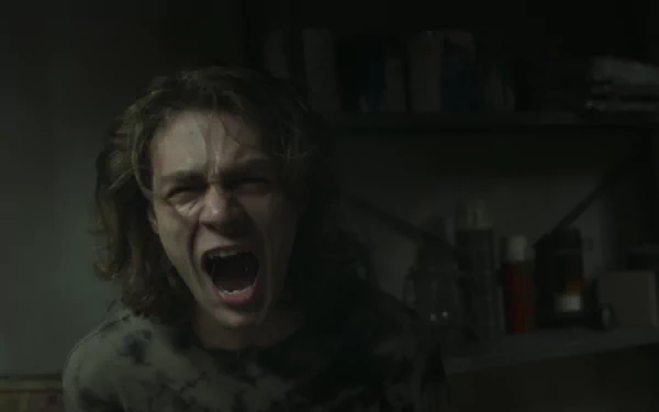 HD desktop wallpaper from Insidious: The Red Door featuring a person screaming in a dimly lit room.