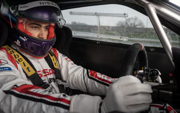 Racing driver in cockpit concentration during a high-speed race, promotional HD desktop wallpaper for Gran Turismo: The Movie.