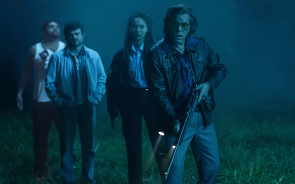 A group of four people looking cautious in a foggy, nighttime setting, from the HD desktop wallpaper themed after Cocaine Bear.