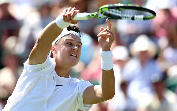 HD desktop wallpaper of a professional tennis player at Wimbledon 2023, captured mid-action during a competitive match, highlighting the intensity and focus of the sport.
