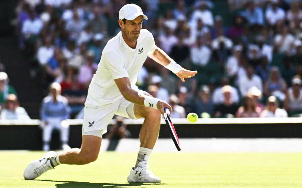 Andy Murray showcases his skills on the grass courts of Wimbledon 2023, executing a swift return during a tennis match, captured in vibrant HD as a dynamic sports wallpaper.