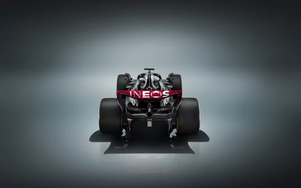 HD desktop wallpaper presenting a frontal view of a Mercedes W14 Formula 1 car, showcased against a sleek, dark gradient background.