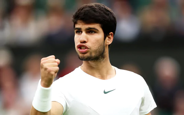 Carlos Alcaraz celebrates during a thrilling match at Wimbledon 2023. This HD desktop wallpaper captures the intensity and excitement of tennis in the spotlight.