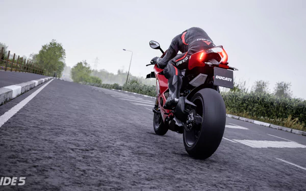 HD desktop wallpaper of a Ducati motorcycle from the video game Ride 5, racing on a damp, tree-lined road.