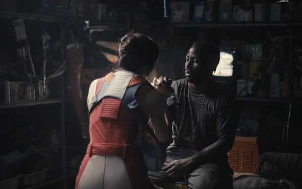 HD wallpaper featuring a dramatic scene from The Creator (2023) with John David Washington and a co-star in an intimate, dimly-lit setting.