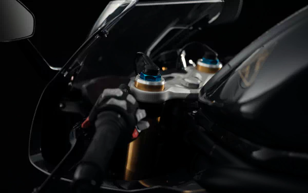 Close-up HD wallpaper of Triumph Speed Triple 1200 RR Bond Edition motorcycle showing detailed handlebars and controls.