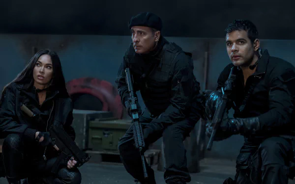 HD desktop wallpaper featuring three actors in tactical gear from the Expend4bles movie, poised for action in a dark, moody setting.